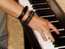 The hand which plays two keys as part of the tuning and adjusting process
